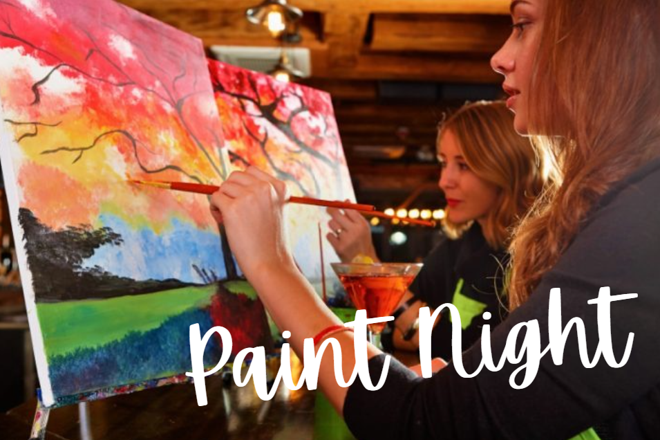 Two women paint a canvas together at Crush Golf and Grill, enjoying a creative moment in a lively bar setting.